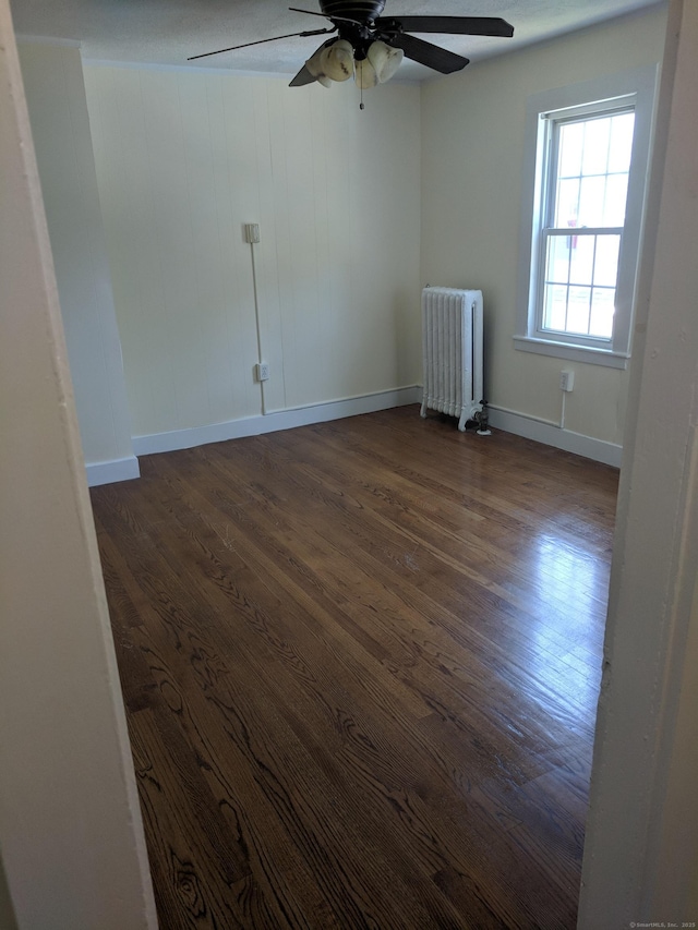 61 Williams St, Norwich, CT 06360 - unfurnished room featuring radiator heating unit, a ceiling fan, dark wood finished floors, and baseboards