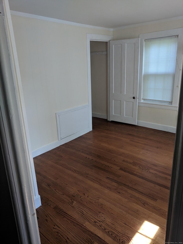 61 Williams St, Norwich, CT 06360 - unfurnished bedroom featuring dark wood finished floors, crown molding, and a closet