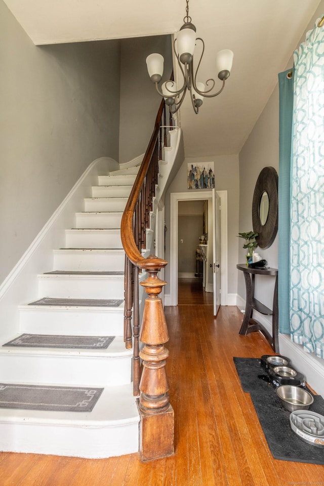 61 Williams St, Norwich, CT 06360 - stairway featuring hardwood / wood-style floors and a chandelier