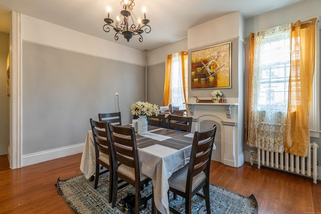 61 Williams St, Norwich, CT 06360 - dining area featuring radiator, a chandelier, wood finished floors, and baseboards