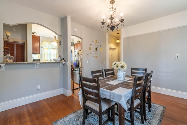 61 Williams St, Norwich, CT 06360 - dining area featuring arched walkways, a chandelier, baseboards, and wood finished floors