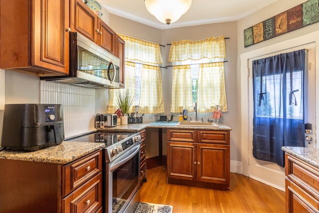61 Williams St, Norwich, CT 06360 - kitchen featuring stainless steel appliances, a sink, plenty of natural light, and light wood-type flooring