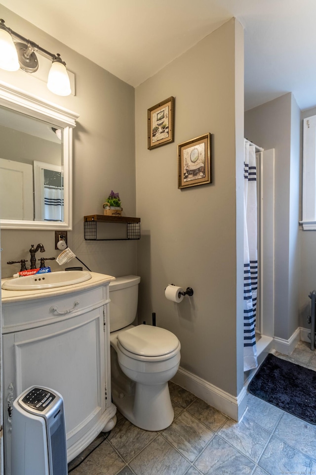 61 Williams St, Norwich, CT 06360 - bathroom featuring toilet, vanity, baseboards, and curtained shower