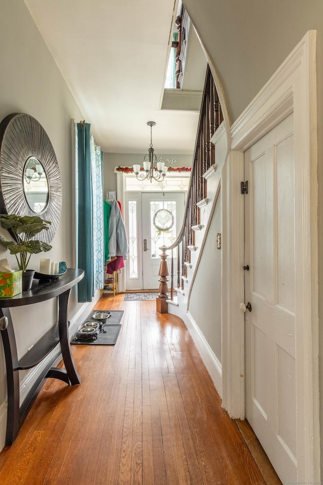 61 Williams St, Norwich, CT 06360 - entrance foyer with a chandelier, stairs, hardwood / wood-style flooring, and baseboards
