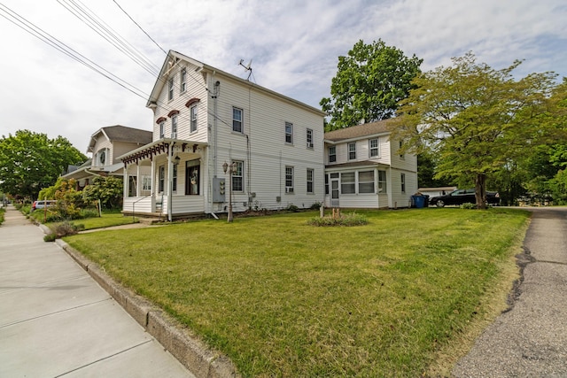 61 Williams St, Norwich, CT 06360 - view of home's exterior with a yard and a sunroom