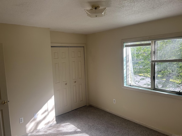 21 Oak Avenue Ext Unit 2, Torrington, CT 06790 - unfurnished bedroom featuring carpet, a closet, and a textured ceiling