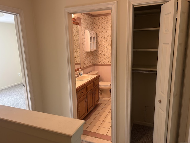21 Oak Avenue Ext Unit 2, Torrington, CT 06790 - bathroom featuring toilet, wainscoting, vanity, wallpapered walls, and a spacious closet