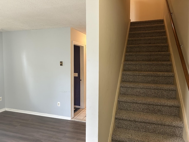 21 Oak Avenue Ext Unit 2, Torrington, CT 06790 - staircase featuring wood finished floors, a textured ceiling, and baseboards