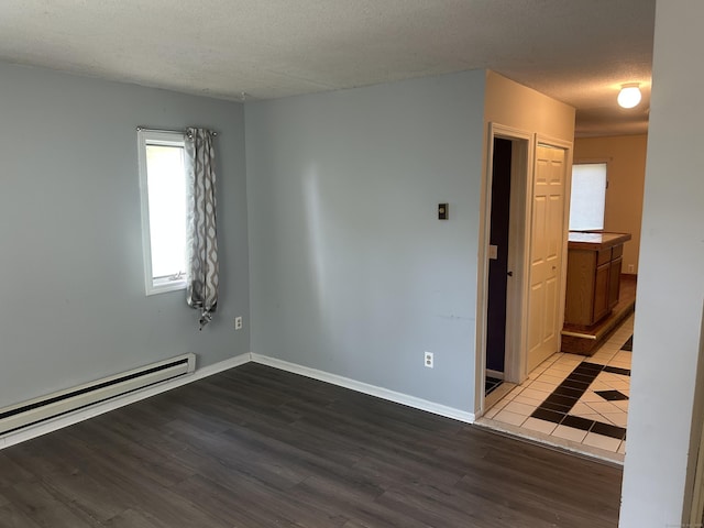 21 Oak Avenue Ext Unit 2, Torrington, CT 06790 - empty room with baseboard heating, wood finished floors, a textured ceiling, and baseboards