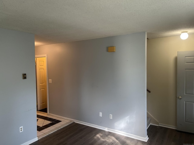 21 Oak Avenue Ext Unit 2, Torrington, CT 06790 - empty room with wood finished floors, stairway, a textured ceiling, and baseboards