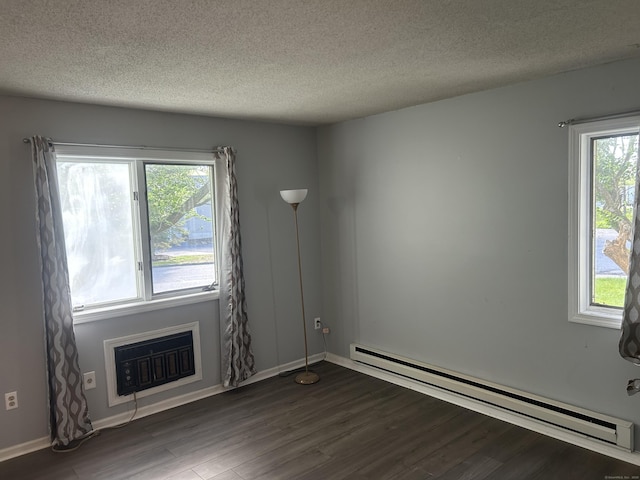 21 Oak Avenue Ext Unit 2, Torrington, CT 06790 - unfurnished room with a baseboard heating unit, dark wood-style flooring, a textured ceiling, plenty of natural light, and baseboards