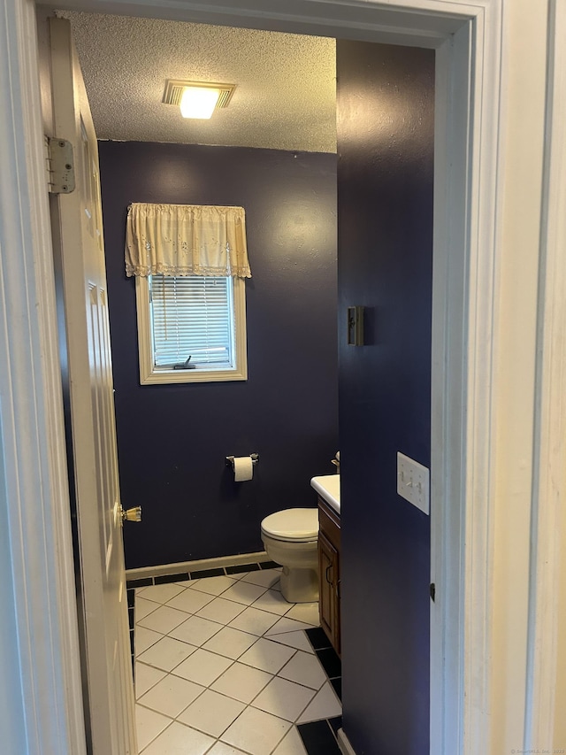 21 Oak Avenue Ext Unit 2, Torrington, CT 06790 - half bath featuring vanity, toilet, tile patterned floors, a textured ceiling, and baseboards