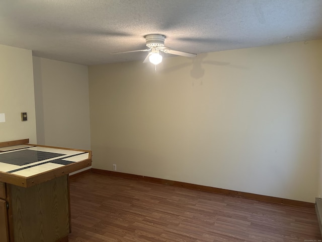 21 Oak Avenue Ext Unit 2, Torrington, CT 06790 - unfurnished room with dark wood-style flooring, a ceiling fan, baseboards, and a textured ceiling