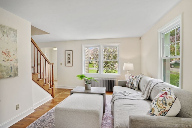 8 Bailey St, Trumbull, CT 06611 - living room with radiator heating unit, stairs, and wood finished floors