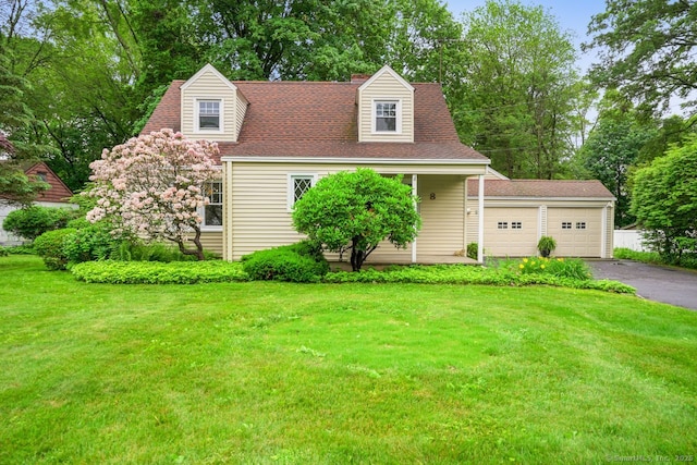 8 Bailey St, Trumbull, CT 06611 - new england style home with a front yard, asphalt driveway, view of scattered trees, and a garage