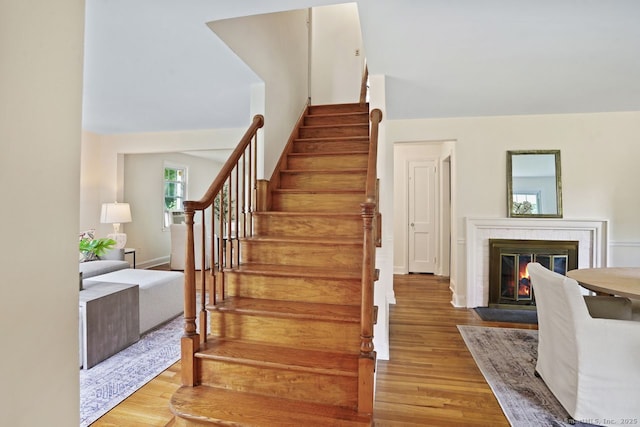 8 Bailey St, Trumbull, CT 06611 - stairway featuring wood finished floors and a fireplace with flush hearth
