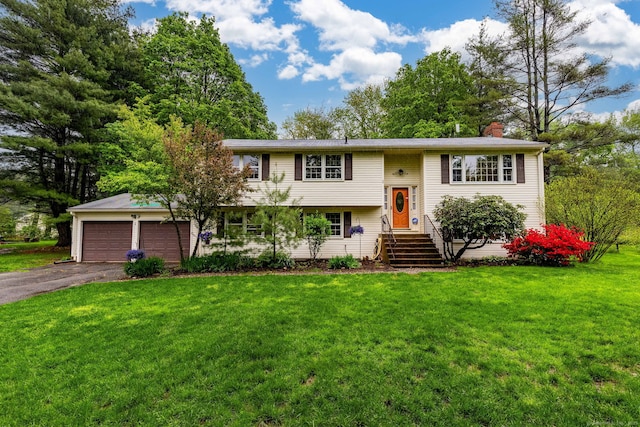 1 Meadowview Ln, Bloomfield, CT 06002 - bi-level home featuring a chimney, asphalt driveway, a front yard, and an attached garage