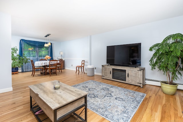 1 Meadowview Ln, Bloomfield, CT 06002 - living room featuring wood finished floors, baseboards, and a baseboard heating unit