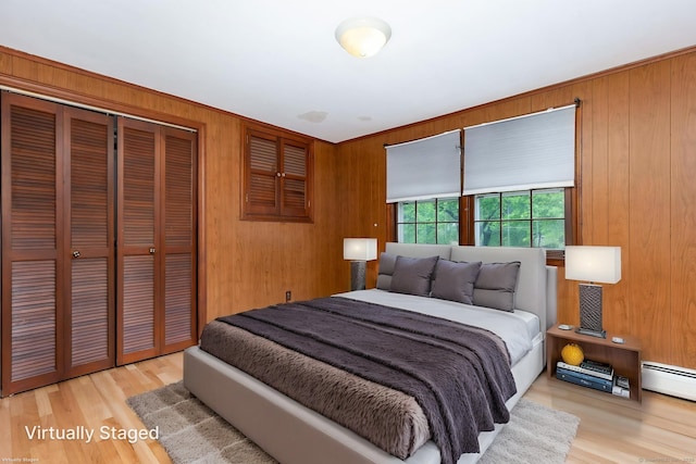 1 Meadowview Ln, Bloomfield, CT 06002 - bedroom with a closet, wood walls, wood finished floors, and a baseboard radiator