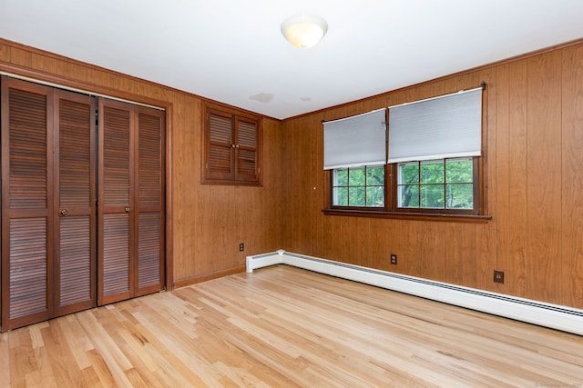 1 Meadowview Ln, Bloomfield, CT 06002 - unfurnished room with a baseboard heating unit, wood finished floors, and wood walls