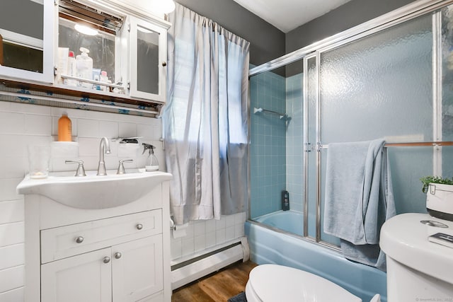 13 Bayberry Ln, Redding, CT 06896 - full bath with a baseboard radiator, toilet, bath / shower combo with glass door, wood finished floors, and vanity