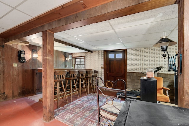 13 Bayberry Ln, Redding, CT 06896 - living room with a dry bar, a drop ceiling, concrete floors, and wooden walls