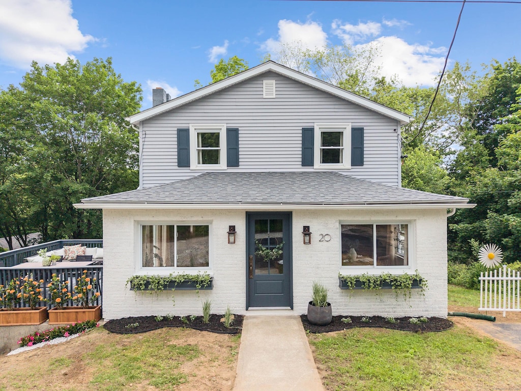 20 Beauregard St, Norwich, CT 06380 - view of front of home featuring brick siding, a shingled roof, a front yard, a deck, and a chimney