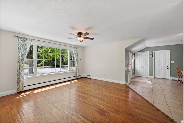 unfurnished room with a baseboard heating unit, a ceiling fan, hardwood / wood-style floors, a baseboard radiator, and baseboards