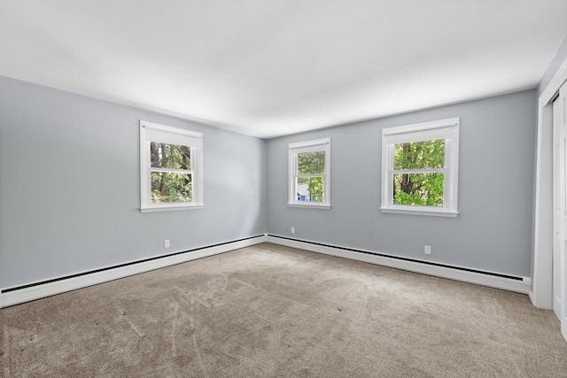empty room featuring carpet floors and baseboard heating