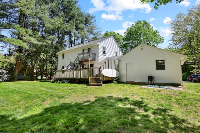 rear view of property with a wooden deck, a yard, and stairway