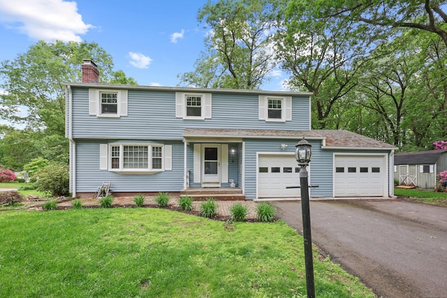 19 Crest Dr, Vernon, CT 06066 - view of front of house featuring a chimney, asphalt driveway, a front lawn, and an attached garage