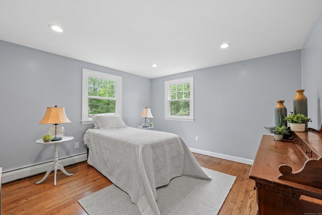 19 Crest Dr, Vernon, CT 06066 - bedroom with a baseboard heating unit, multiple windows, wood finished floors, baseboards, and recessed lighting