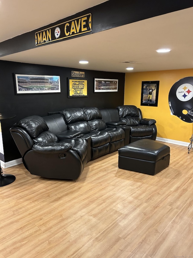 living area featuring wood finished floors, baseboards, and recessed lighting