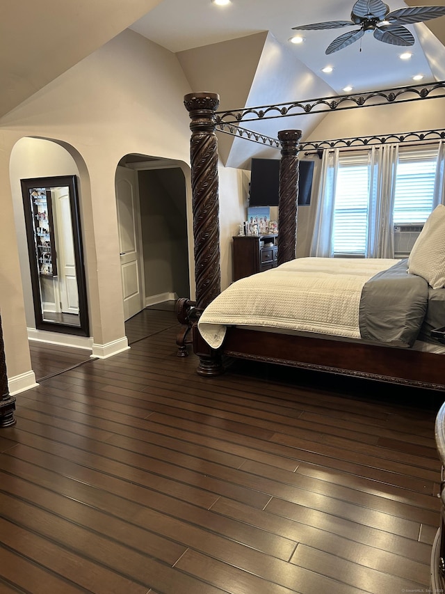 bedroom featuring lofted ceiling, baseboards, dark wood finished floors, arched walkways, and recessed lighting