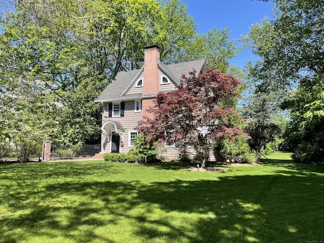 26 Ridgewood Rd, West Hartford, CT 06107 - view of front of home featuring a front lawn and a chimney