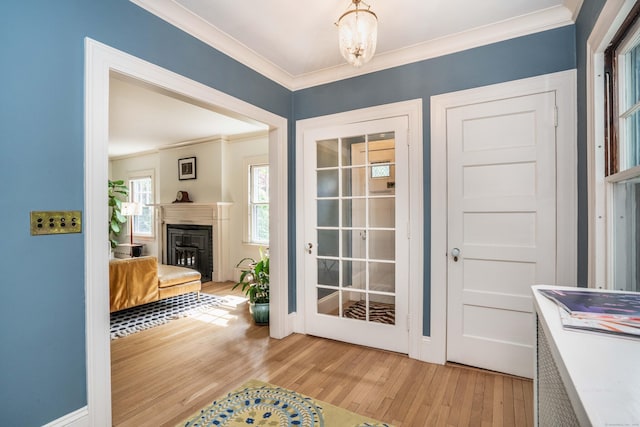26 Ridgewood Rd, West Hartford, CT 06107 - entryway featuring light wood-type flooring, ornamental molding, a fireplace, and baseboards