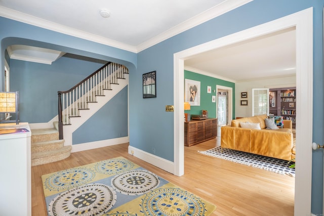 26 Ridgewood Rd, West Hartford, CT 06107 - entrance foyer featuring wood finished floors, arched walkways, ornamental molding, stairs, and baseboards