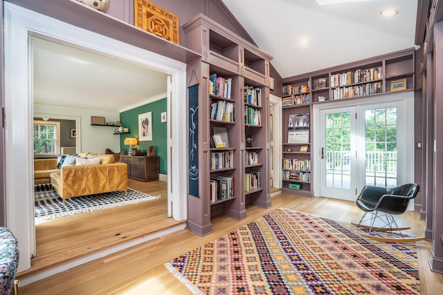 26 Ridgewood Rd, West Hartford, CT 06107 - living area with healthy amount of natural light, crown molding, light wood-style floors, vaulted ceiling, and baseboards