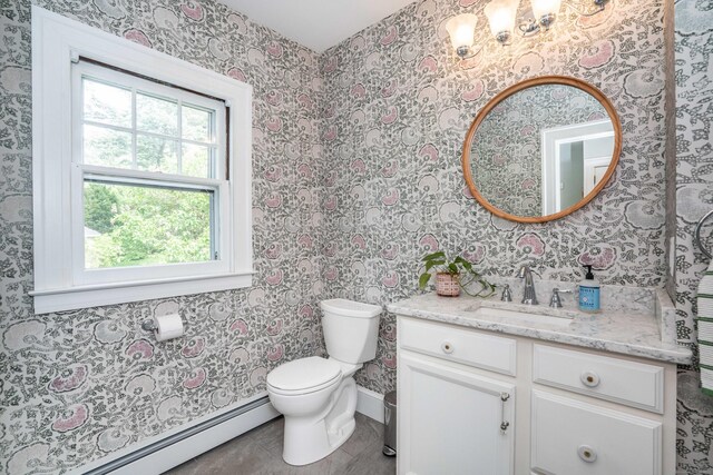 26 Ridgewood Rd, West Hartford, CT 06107 - bathroom with a baseboard radiator, toilet, vanity, baseboards, and wallpapered walls