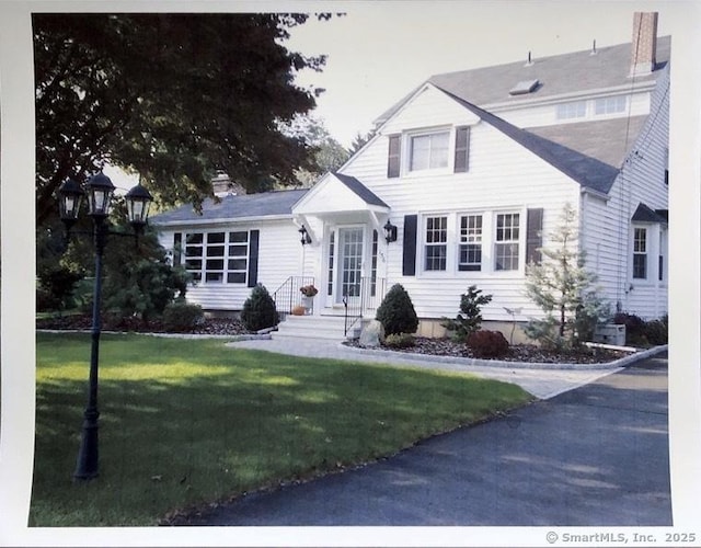 156 Russell Ave, Orange, CT 06477 - view of front of home with a front yard and a chimney