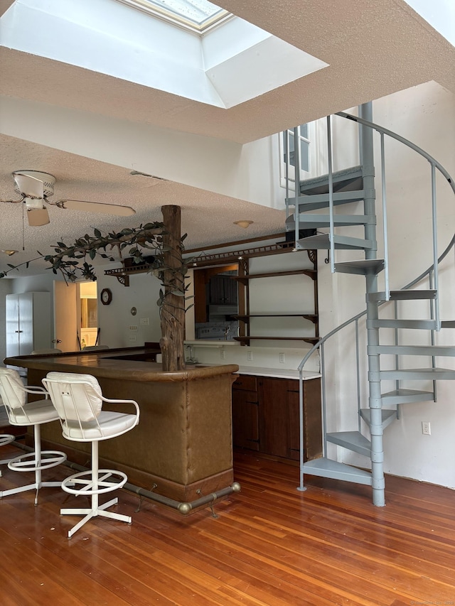 156 Russell Ave, Orange, CT 06477 - kitchen featuring hardwood / wood-style floors, a skylight, and a textured ceiling