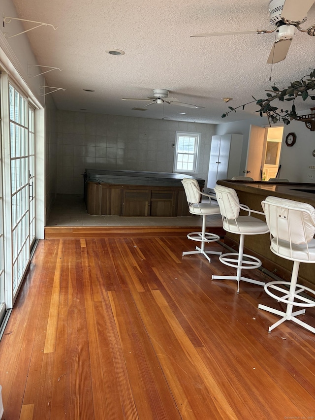 156 Russell Ave, Orange, CT 06477 - dining room featuring a ceiling fan, hardwood / wood-style flooring, and a textured ceiling