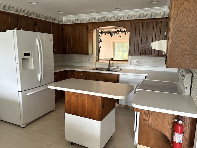 156 Russell Ave, Orange, CT 06477 - kitchen featuring white appliances, under cabinet range hood, a center island, light countertops, and tasteful backsplash
