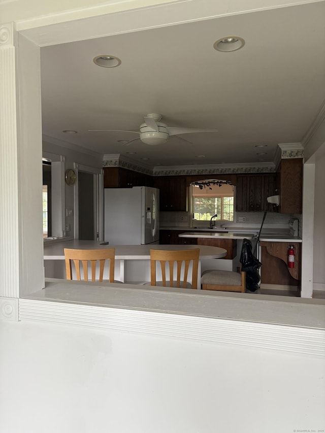 156 Russell Ave, Orange, CT 06477 - kitchen with white fridge with ice dispenser, ceiling fan, crown molding, recessed lighting, and dark brown cabinetry