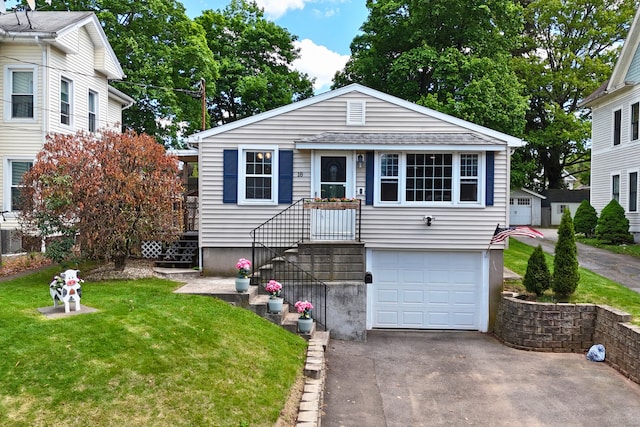 18 Simpson Ave, Wallingford, CT 06492 - view of front of house with driveway, a front yard, and a garage