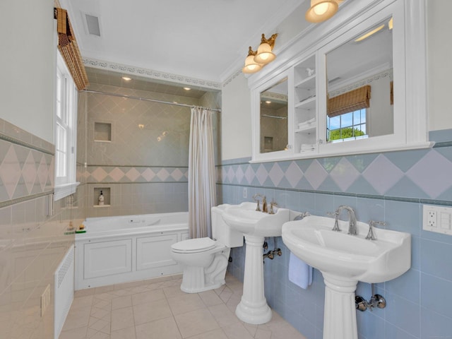 226 Alberta St, Fairfield, CT 06825 - bathroom with tile walls, tile patterned flooring, shower / bath combo with shower curtain, toilet, and a wainscoted wall