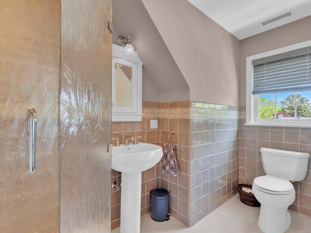 226 Alberta St, Fairfield, CT 06825 - bathroom featuring tile walls, tile patterned floors, toilet, a sink, and wainscoting