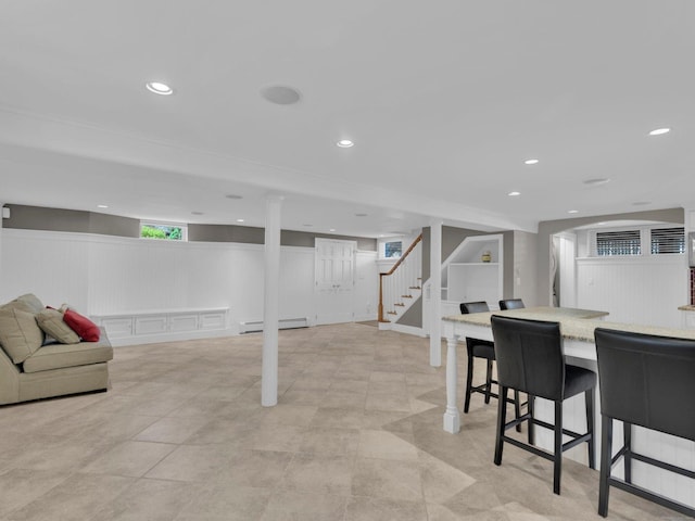 226 Alberta St, Fairfield, CT 06825 - basement with stairway, a baseboard heating unit, recessed lighting, a wainscoted wall, and a decorative wall