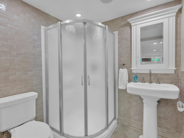 226 Alberta St, Fairfield, CT 06825 - full bathroom with tile walls, a stall shower, toilet, tile patterned flooring, and recessed lighting