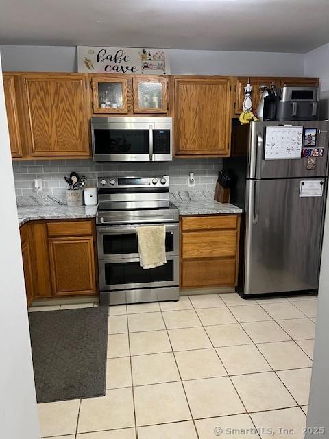 6 Hakim St Unit 2-6, Danbury, CT 06810 - kitchen with appliances with stainless steel finishes, brown cabinetry, and tasteful backsplash